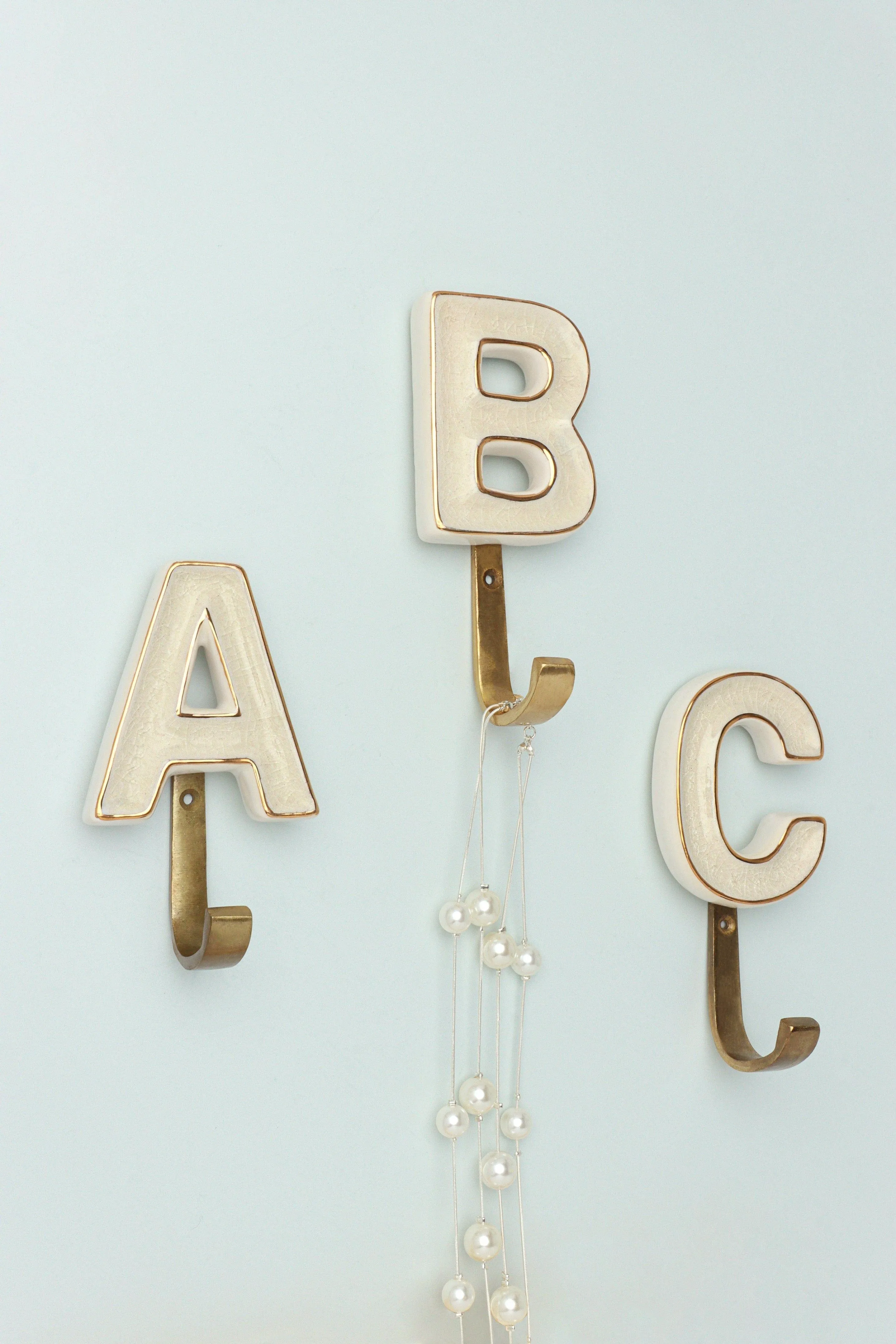 Alphabet Cream Crackle Glazed Hooks In Antique Brass