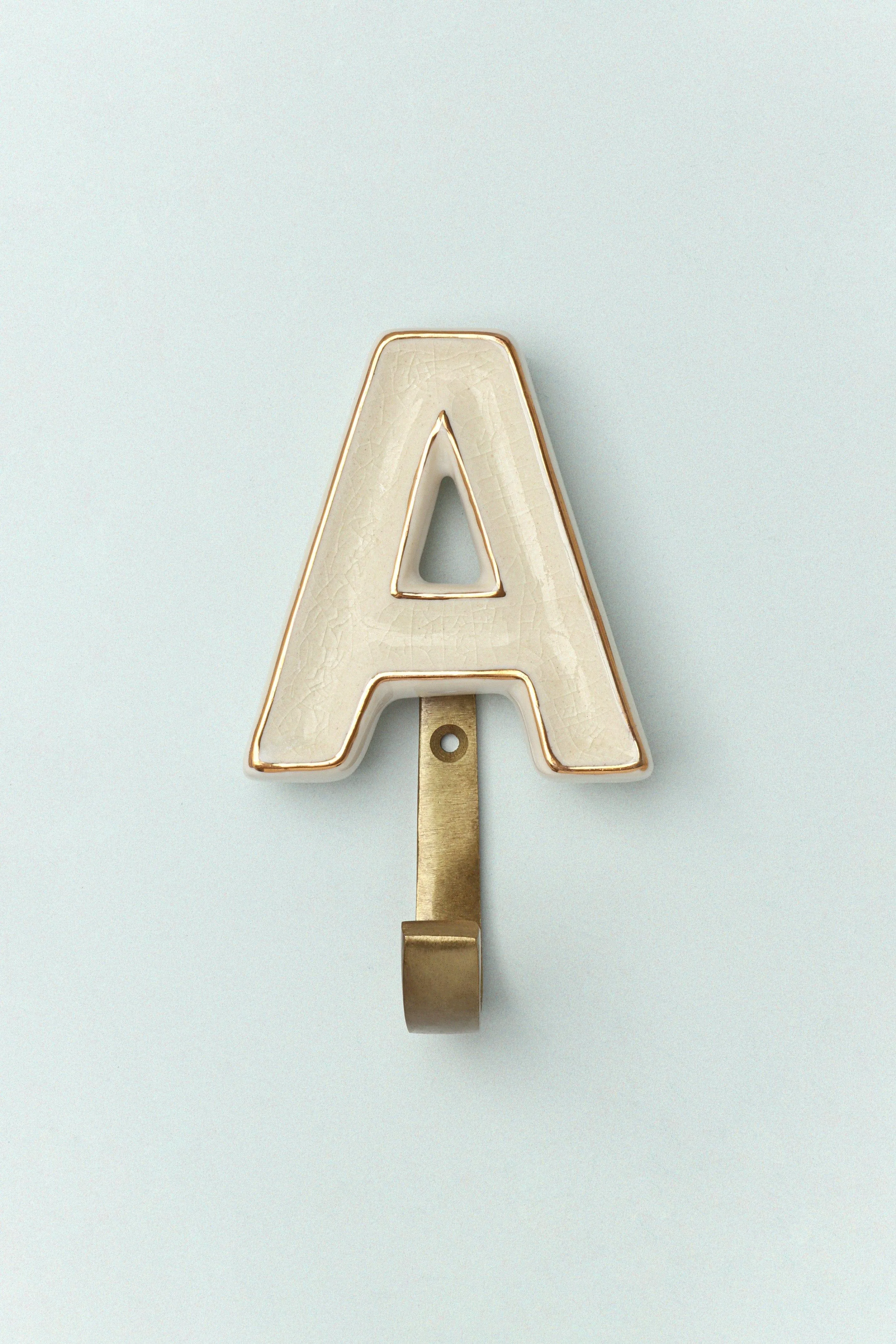 Alphabet Cream Crackle Glazed Hooks In Antique Brass